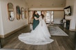 Bride Getting Ready Buttoning Up Romantic Lace Long Sleeve Ball Gown Called Mallory Dawn By Maggie Sottero