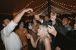 Guests drinking and dancing at reception