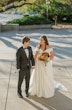 Bride Wearing Satin Aline Wedding Dress Called Ekaterina By Maggie Sottero Holding Hands With Groom