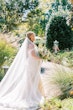 Bride Wearing Sexy Lace Wedding Dress Called Lennon By Maggie Sottero Walking Through A Garden