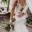 Bride wearing Sydney by Maggie Sottero being embraced by her husband
