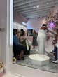 Bride Wearing Deep V-Neck Wedding Dress Called Jace By Maggie Sottero Putting On Gloves In A Dressing Room