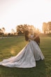 Bride Wearing Princess Wedding Dress Called Norvinia By Sottero And Midgley Kissing The Groom In A Field