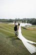 Bride wearing Tuscany Royale by Maggie Sottero walking with her husband