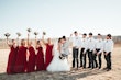 Bride In Tulle A-Line Wedding Dress Called Lorraine Lane Marie By Rebecca Ingram With Bridesmaids In Red And Groomsmen In Ball Caps