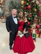 Bride Wearing Red Aline Wedding Dress Called Scarlet By Maggie Sottero Next To A Christmas Tree And Her Dad