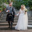 Bride wearing Iris wedding dress by Rebecca Ingram holding hands with her husband