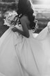 Bride wearing Derrick by Maggie Sottero carrying her bouquet