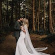 Bride wearing Summer wedding dress by Maggie Sottero kissing husband