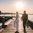 Bride Wearing Beaded Wedding Dress Called Luella By Sottero And Midgley Walking With Groom Along A Pier
