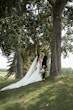 Bride wearing Tuscany Royale by Maggie Sottero standing with her husband