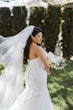 Bride wearing Hattie Lynette wedding dress by Rebecca Ingram holding bouquet