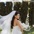 Bride wearing Hattie Lynette wedding dress by Rebecca Ingram holding bouquet