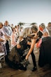 Bride Wearing Black Fit And Flare Wedding Dress Called Zander Lane By Sottero And Midgley Kissing Groom After The Ceremony