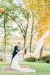 Bride In Sheath Wedding Dress Called Alberta By Maggie Sottero With Groom And Dramatic Veil