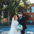 Bride And Groom Standing Together. Bride Wearing Illusion Sleeve A-line Wedding Dress Called Raphael By Maggie Sottero With Cathedral Veil