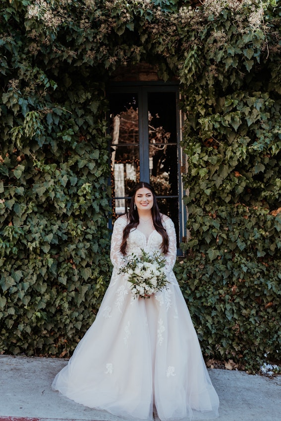 Real Bride wearing long sleeve A-Line wedding dress called Raphael by Maggie Sottero.