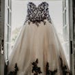 Gothic Black Lace Wedding Dress Called Tristyn By Maggie Sottero Hanging From A Window