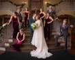 Bride wearing Seneca wedding dress by Sottero and Midgley surrounded by bridal party