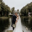 Bride wearing Rousseau wedding dress by Maggie Sottero with her groom