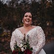 Plus Size Bride In Lace Long Sleeve Wedding Dress Called Mallory Dawn By Maggie Sottero Holding Red Bouquet