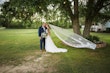 Groom with Bride in Beaded Chiffon Sheath Wedding Dress Called Lorraine by Rebecca Ingram