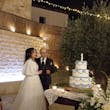 Bride Wearing Glam Long Sleeve Wedding Dress Called Seneca By Sottero And Midgley With Groom Cutting The Cake