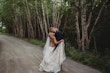 Bride and groom kissing on dirt road.