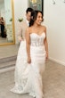 Bride Wearing Lace Fit And Flare Wedding Dress Called Fairchild By Maggie Sottero With Groom Holding Her Train