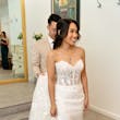 Bride Wearing Lace Fit And Flare Wedding Dress Called Fairchild By Maggie Sottero With Groom Holding Her Train
