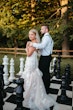 Bride wearing Hattie Lynette by Rebecca Ingram with her husband on a giant chess board