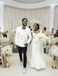 Bride Wearing Simple Fit and Flare Wedding Dress Called Anniston Lane Walking Hand In Hand With Groom