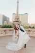 Groom and Bride Kissing at a Las Vegas Wedding Wearing Lace Ballgown Called Ellen by Rebecca Ingram