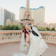 Groom and Bride Kissing at a Las Vegas Wedding Wearing Lace Ballgown Called Ellen by Rebecca Ingram