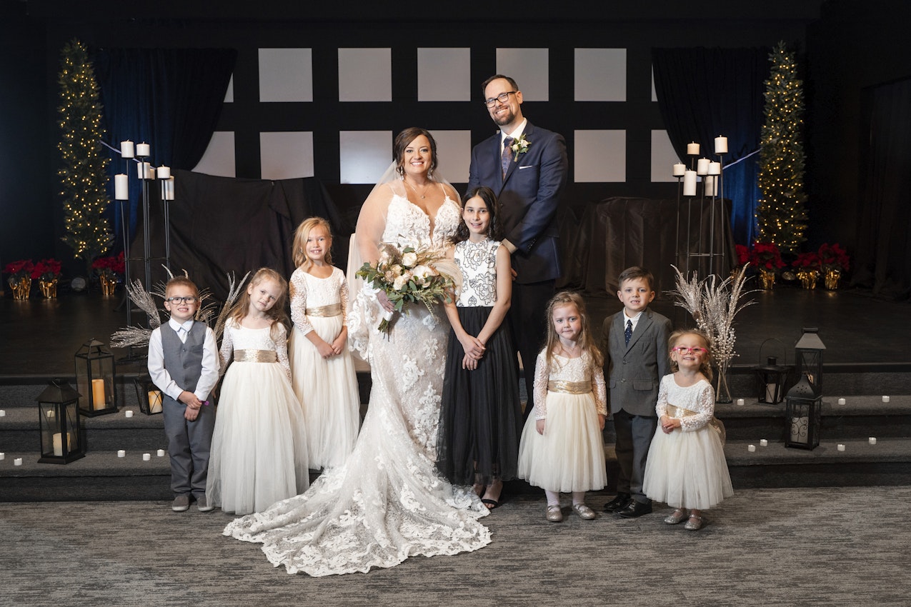 Bride With Husband and Family Wearing Wedding Dress Called Tuscany Marie by Maggie Sottero