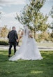 Bride wearing Danielle by Maggie Sottero walking with her husband