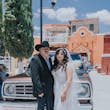 Groom with Bride at Old Western Themed Wedding Wearing a Romantic Wedding Gown Called Priscilla by Rebecca Ingram.