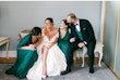 Bride wearing Ekaterina by Maggie Sottero laughing with her bridal party