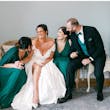 Bride wearing Ekaterina by Maggie Sottero laughing with her bridal party