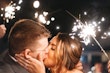 Bride Kissing Groom Surrounded By Sparklers