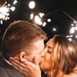Bride Kissing Groom Surrounded By Sparklers