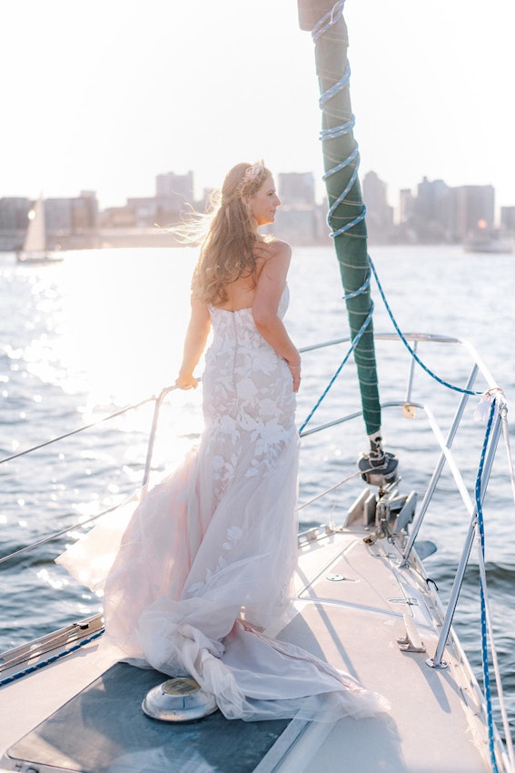 Bride wearing strapless mermaid wedding dress with plunging V-neck.