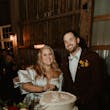 Bride wearing Juniper wedding dress by Sottero and Midgley cutting the cake with her husband