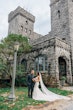 Groom Smiling at Bride Wearing A Fitted White Wedding Dress Named Veronique by Maggie Sottero