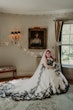 Bride Wearing Gothic Black Lace Wedding Dress Called Tristyn By Maggie Sottero Holding Black and White Floral Bouquet