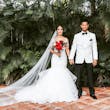 Bride with groom wearing glamorous mermaid wedding dress