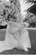 Bride wearing Tuscany Royale by Maggie Sottero playing under her veil with a little girl