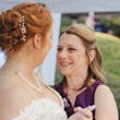 Bride Wearing Chiffon A-Line Wedding Dress Called Heather By Rebecca Ingram Dancing With Her Mom