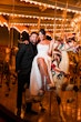 Bride Wearing Modern Ballgown Wedding Dress Called Aspen By Sottero And Midgley With Groom On A Carousel