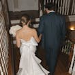 Bride Wearing Simple Mermaid Wedding Dress Called Mitchell By Maggie Sottero Walking Down The Stairs With Groom
